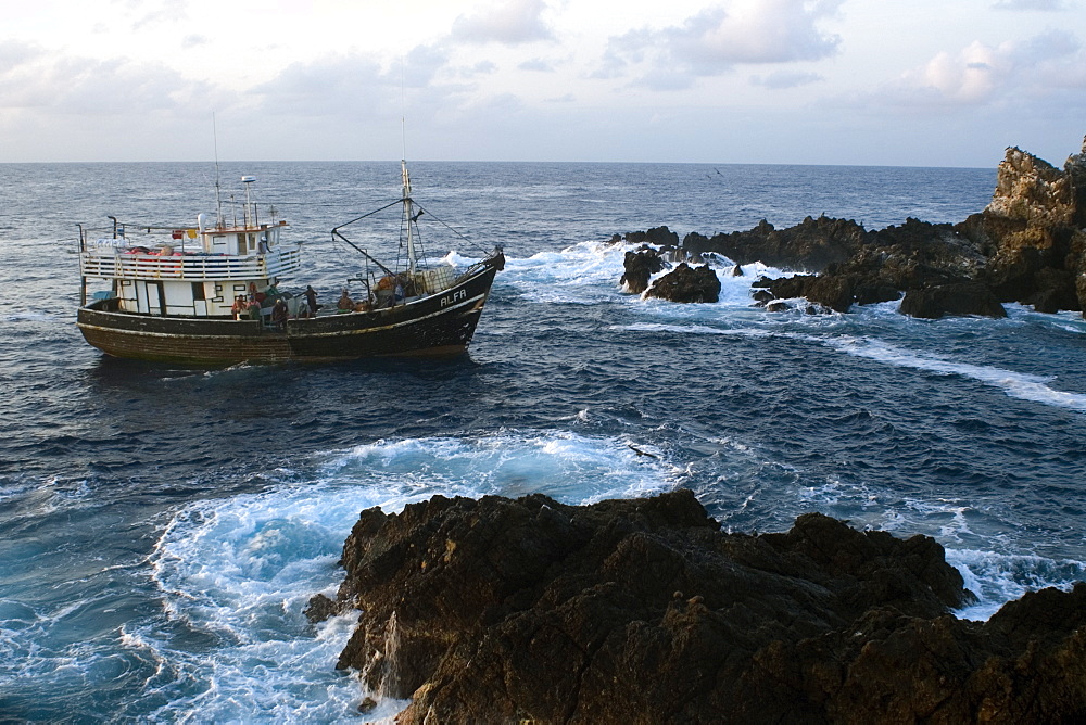 Fishing boat near bay, St. Peter and St. Paul's rocks, Brazil, South America