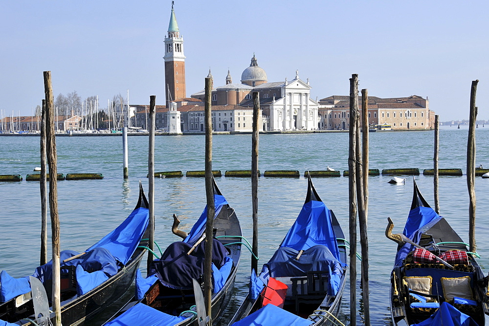 Four gondolas parked in Venetian lagoon, with San Giorgio Maggiore Island in the background, Venice, UNESCO World Heritage Site, Veneto, Italy, Europe