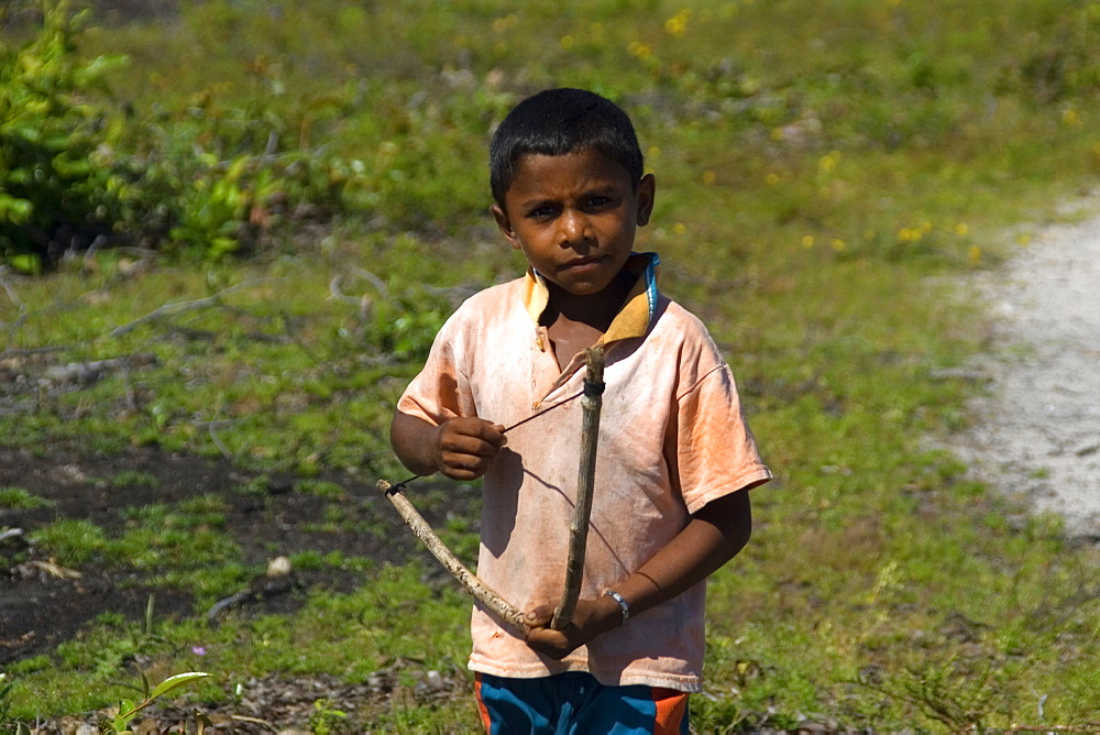 Boy plays with a bow, Santo Amaro, Maranhao, Brazil, South America