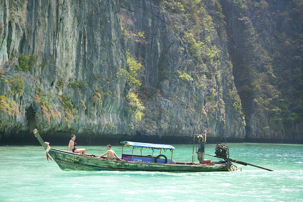 The Cove, tourists sunbathing on boat.  Ko Phi Phi Lee, Krabi, Thailand, Asia