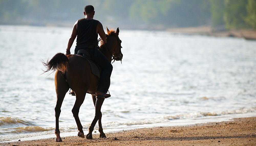 Horse riding along beach, Ao Nam Mao.  Ao Nang, Krabi, Thailand, Asia