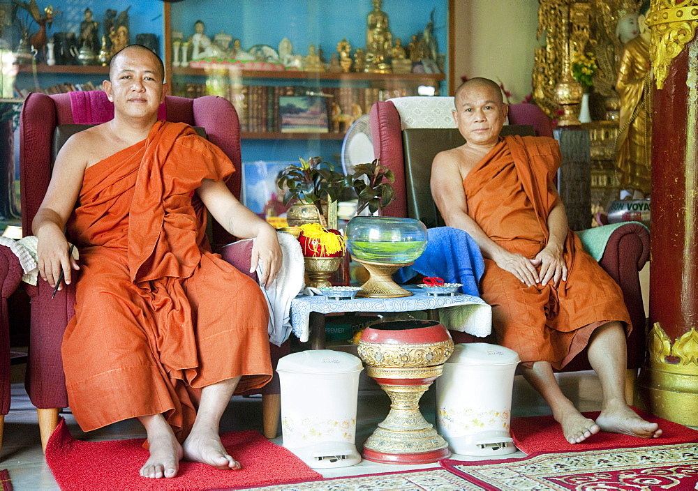 Adult male monks, sitting, Dhammikarama Burmese Temple.  George Town, Thailand, Asia