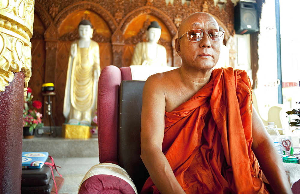 Adult male monks, sitting, Dhammikarama Burmese Temple.  George Town, Thailand, Asia