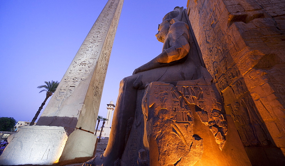 Obelisk and colossal statue of Rameses II on his thron, Luxor Temple. Luxor, Nile Valley, Egypt, Africa 