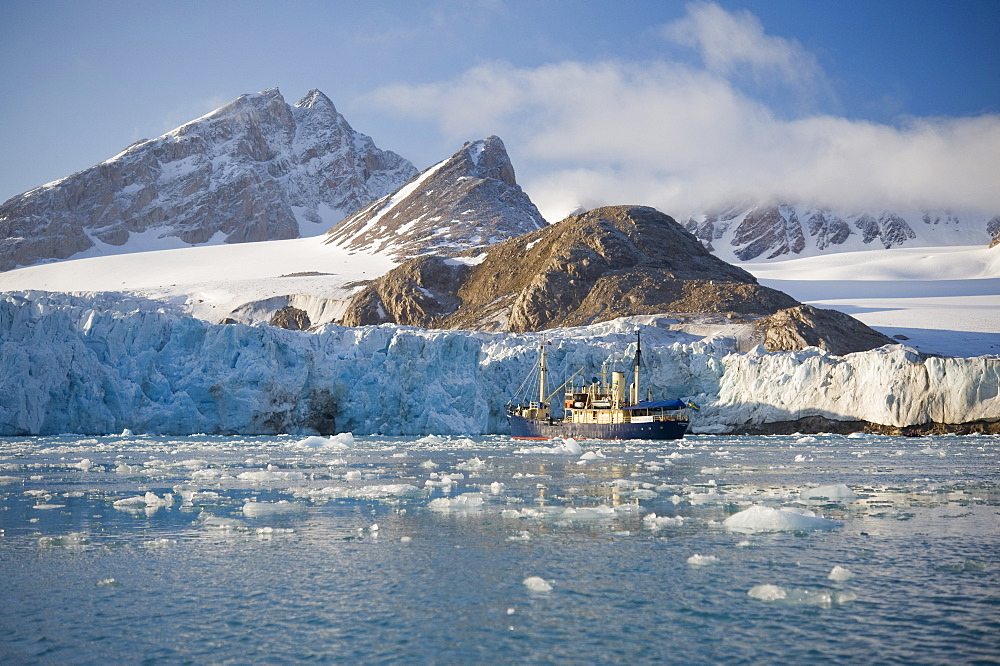 Tourist ship by Glacier face. Longyearbyne, Svalbard, Norway