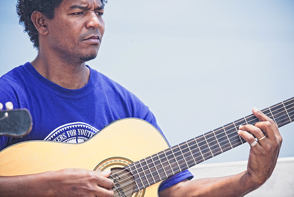 04/04/2009. Live music by the beach in Bahia dos Gatos. Man playing acoustic guitar. Mindelo, Sao Vicente Island Of the Cape Verde Islands. Mindelo, Baia Das Gates, Sao Vicente Island. Cape Verde Islands