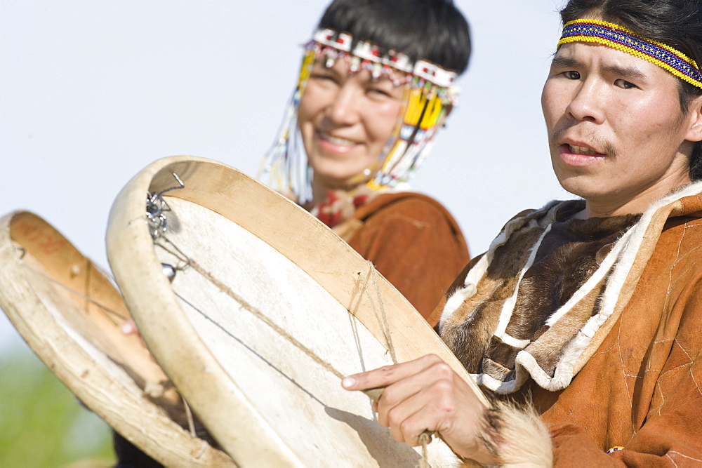 Inuits Male and Female  of the Koryaks peoples in native clothes playing drums, Ossora Village (Koryakskiy Peninsular) Russia, Asia