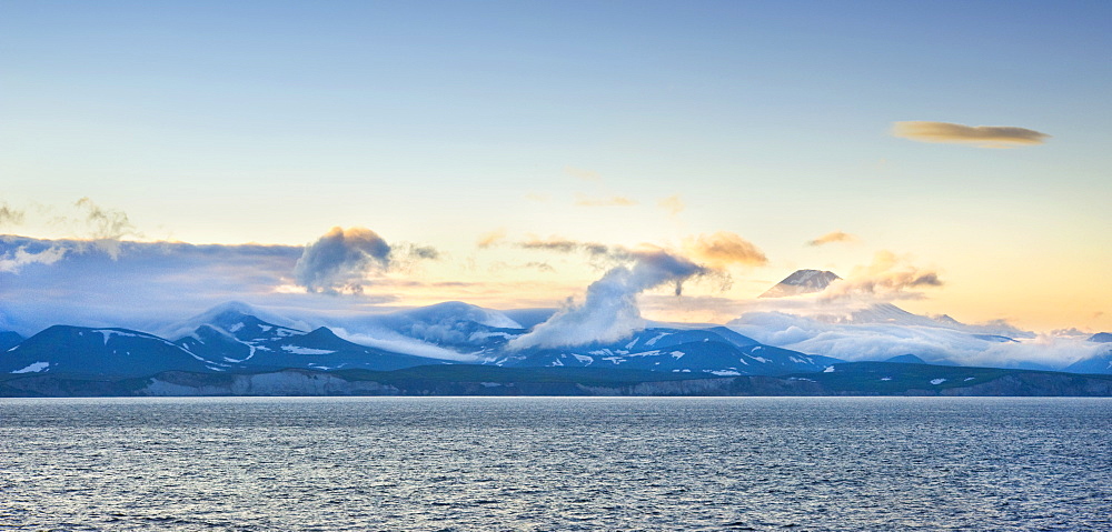 Views from the Clipper Odyssey towards Russkaya Bay of volcanic mountains in mist and sun set, Russkaya Bay (Bering Sea), Russia, Asia.