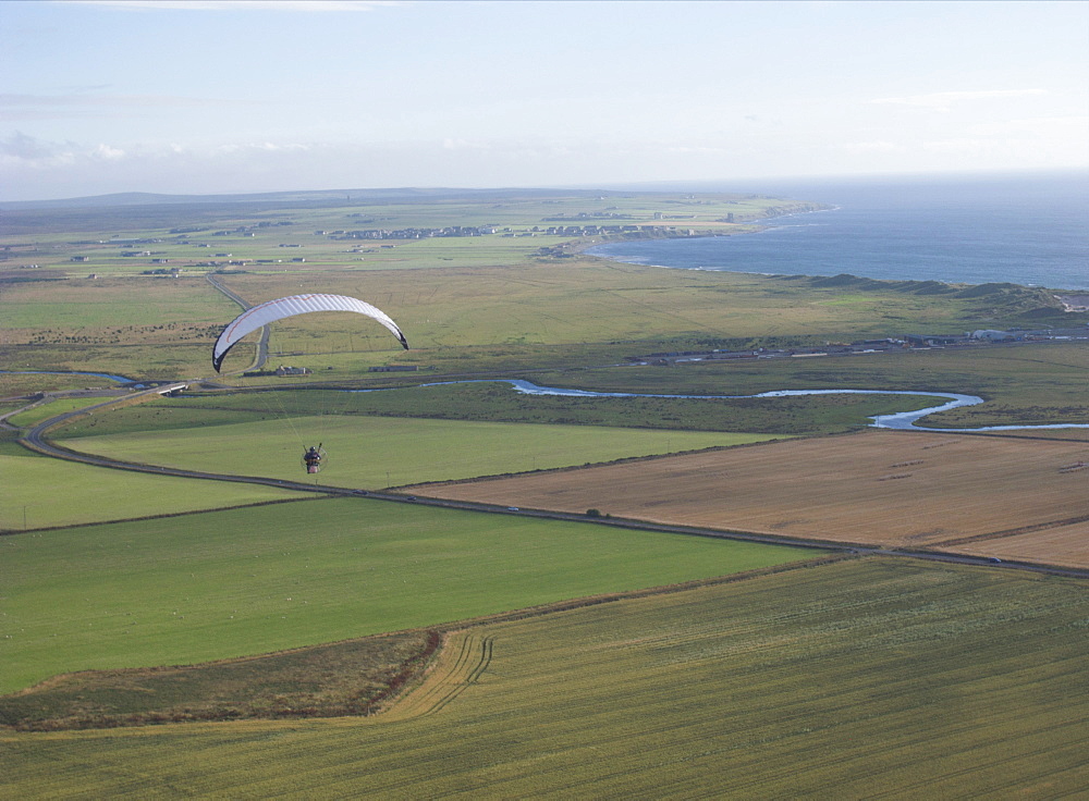 Paramotoring over  the Scottish flats near Wick near John O'Groats. Scotland, UK