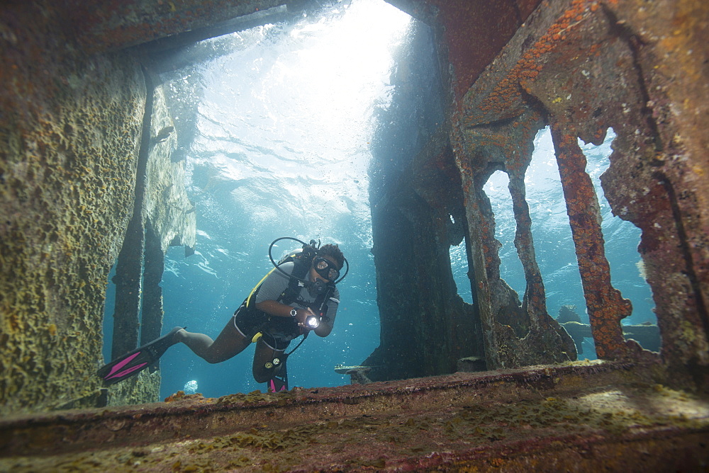 Diver diving on ship wreck in the Turks and Caicos Islands, West Indies, Central America