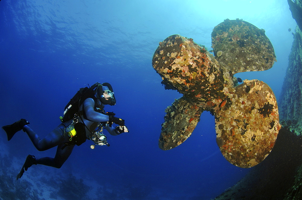 Mixed gas rebreather divers by ship wreck, with propeller in tact.  Red Sea.