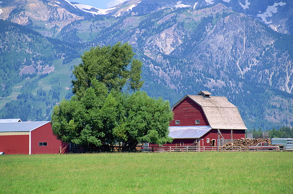 Farm buildings with mountain slopes behind, Jackson Hole, Wyoming, United States of America, North America