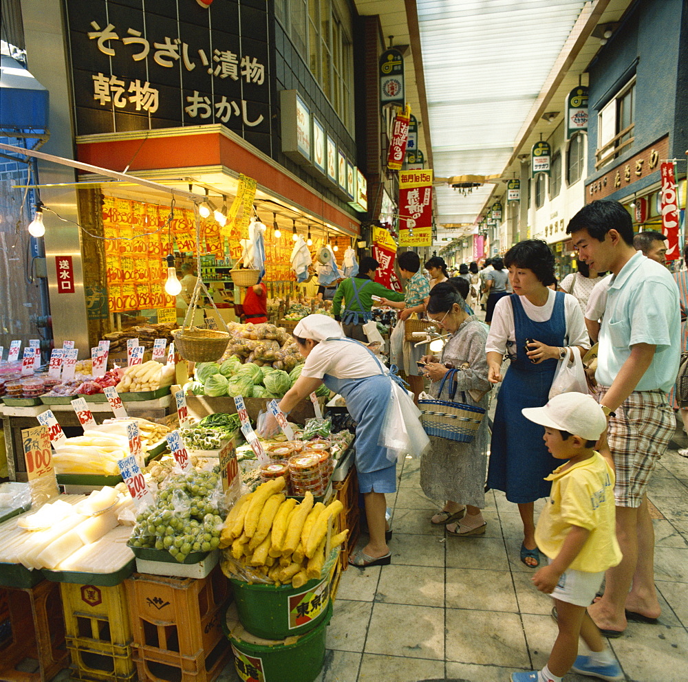 Family shopping in a covered market in Tokyo, Honshu, Japan, Asia