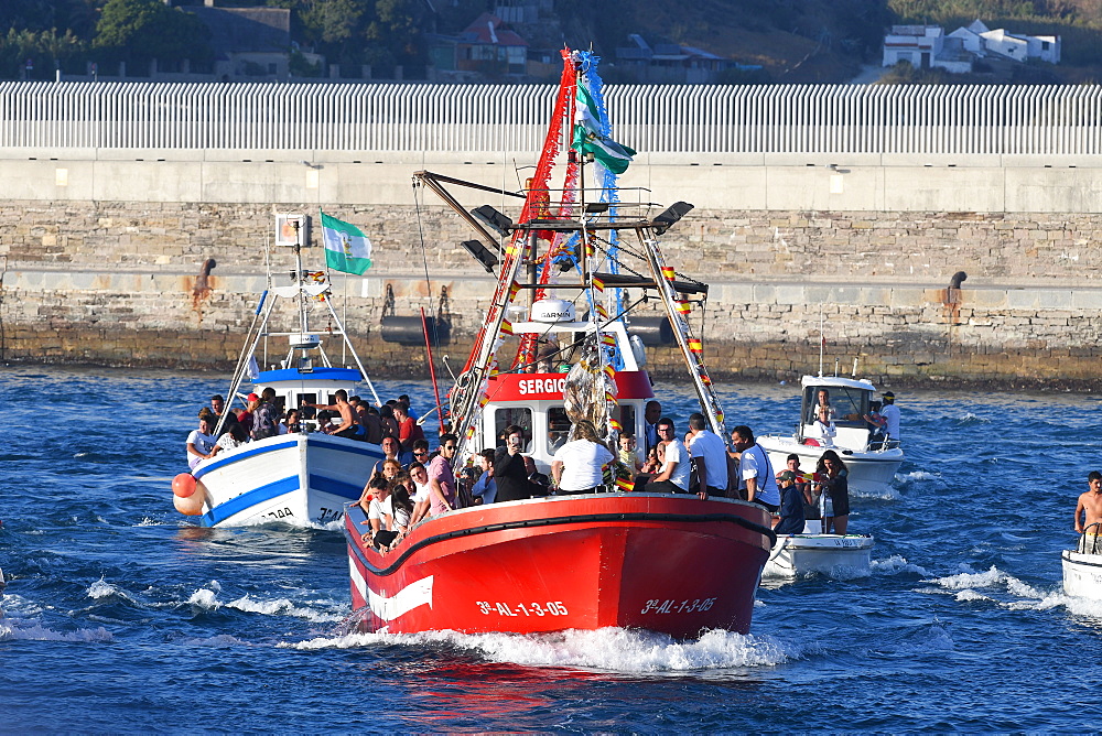 The Virgen del Carmen, wrapped in protective plastic, being carried out to sea from Tarifa, accompanied by a flotilla of boats, Tarifa, Cadiz, Andalusia, Spain, Europe