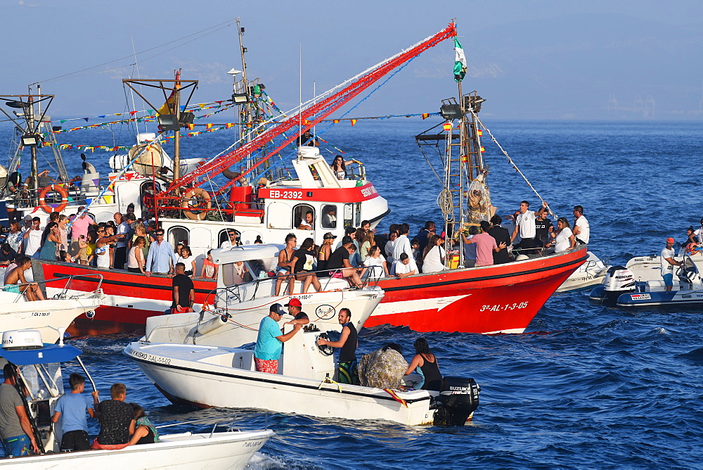 Chaotic scene at sea, as the Virgen del Carmen from Tarifa is taken on an annual ritual voyage with small boats in attendance, Cadiz, Andalusia, Spain, Europe