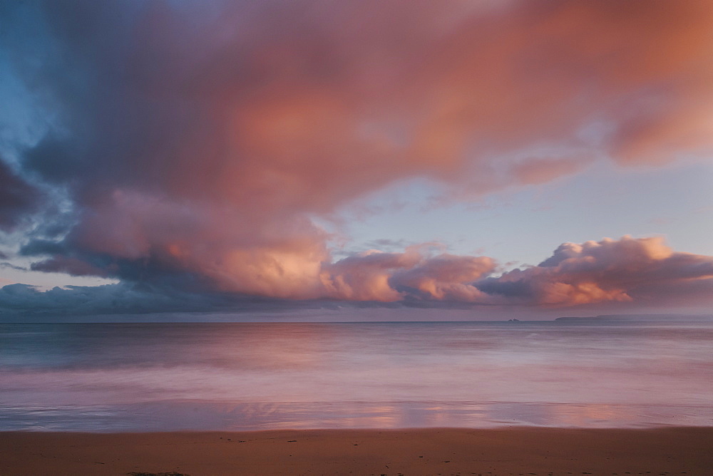 Dawn sky over Carbis Bay beach looking to Godrevy point, St. Ives, Cornwall, England, UK, Europe. Long exposure