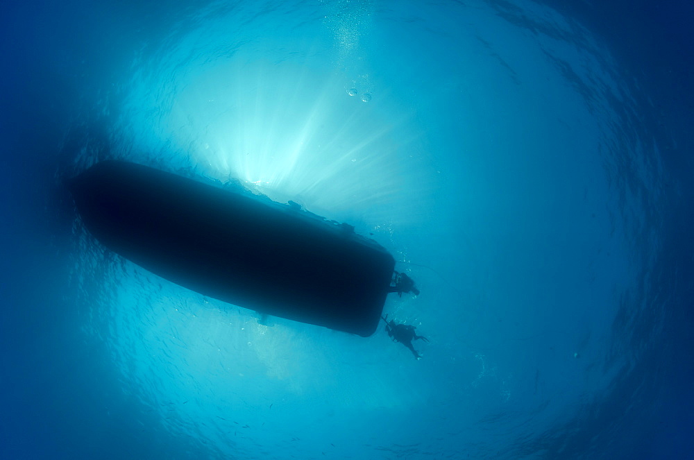 Silhouette of dive boat with scuba divers at dive ladders, underwater view, Red Sea, Egypt, North Africa, Africa