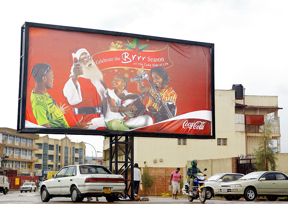 A bill board advertising Coca Cola at Christmas time with a truly Rwandan Twist.  It's prominence illustrates the far reaching appeal of the brand. Kigali, Rwanda, East Africa