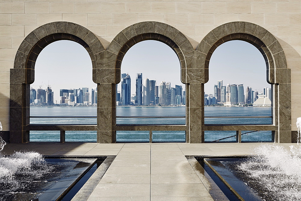 Downtown Doha with its impressive skyline of skyscrapers as seen from the Museum of Islamic Arts, across the bay, Doha, Qatar, Middle East