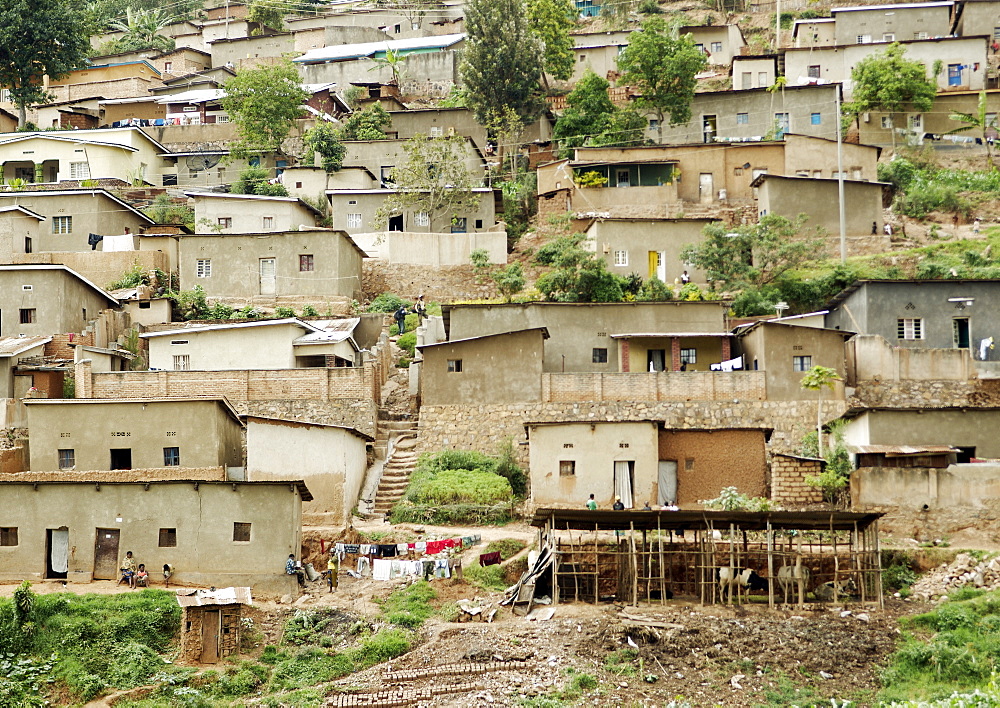 Staple housing for many of the residents of Kigali, these basic huts have no running water or electricity and communities like this cover much of the Kigali Urban sprawl. Kigali, Rwanda, East Africa