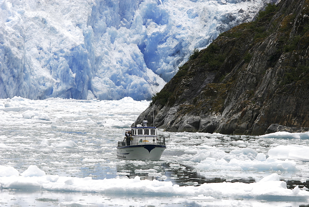 A tour ship navigates the ice of the Le Conte and Patterson Glaciers, the Stikine Ice Field, and the mountains surrounding the town of Petersburg, Southeast Alaska, USA.