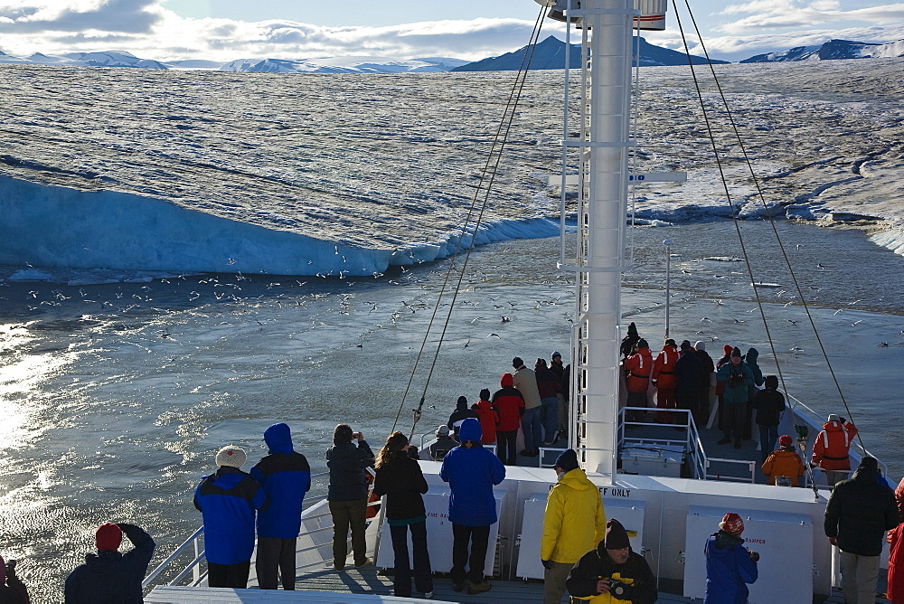 Late evening view from the National Geographic Endeavour of the Negrebreen Glacier melting in the sunlight on Spitsbergen Island in the Svalbard Archipelago, Barents Sea, Norway.