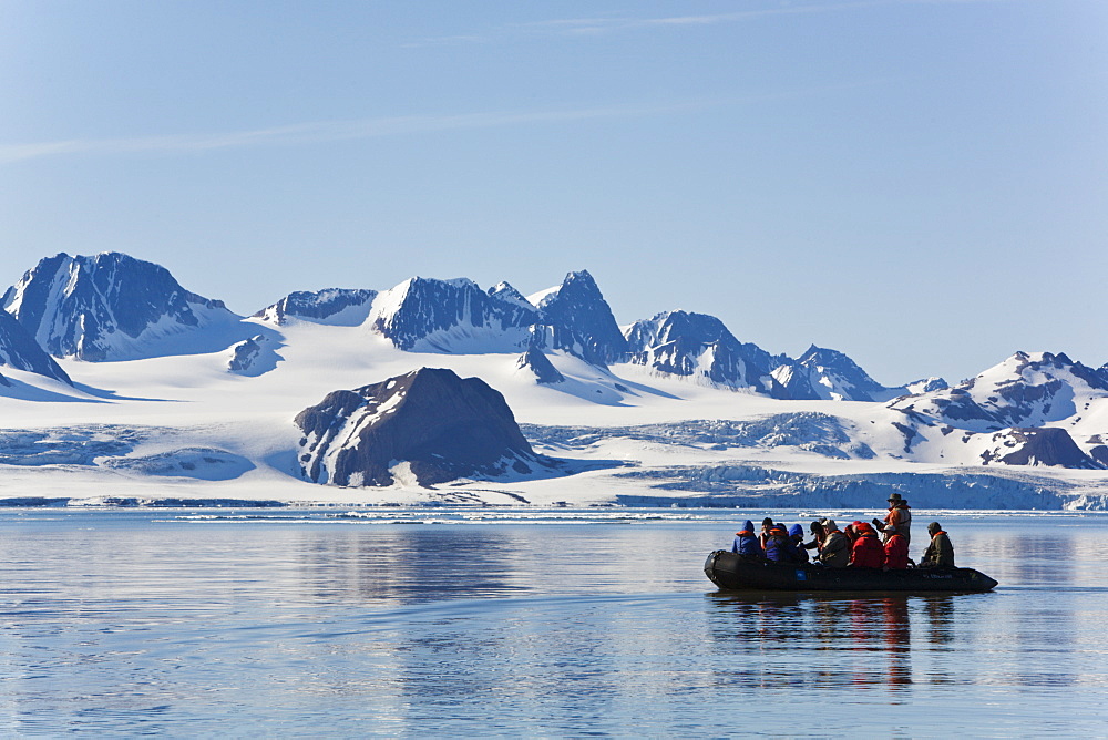 Zodiac cruisers get a view of the tidewater glacier in Isbukta (Ice Bay) on the western side of Spitsbergen Island in the Svalbard Archipelago, Barents Sea, Norway