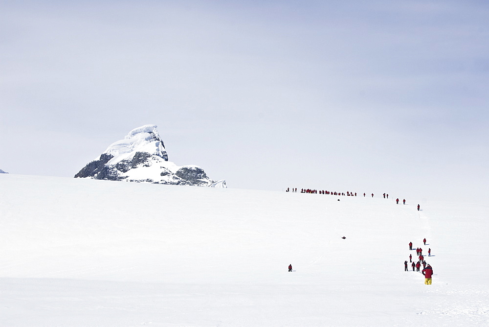 Lindblad Expeditions guests hiking on a glacier in Antarctica as part of expedition travel. NO MODEL RELEASES FOR THIS IMAGE.