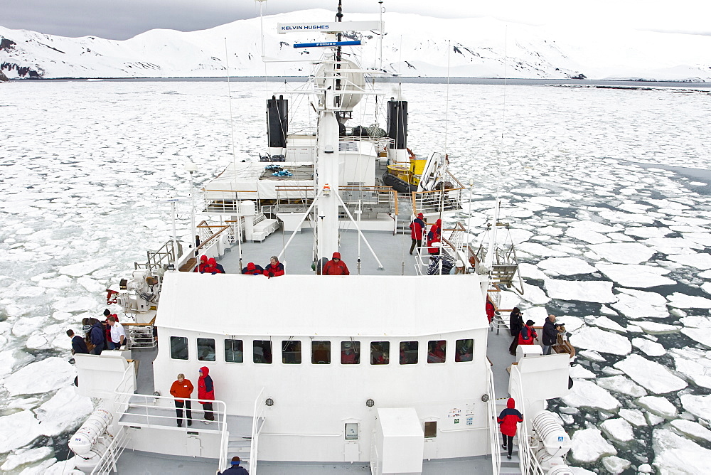 The Lindblad expedition ship National Geographic Endeavour operating in shre fast ice in Port Foster within the caldera at Deception Island, South Shetland Island Group, Antarctica.