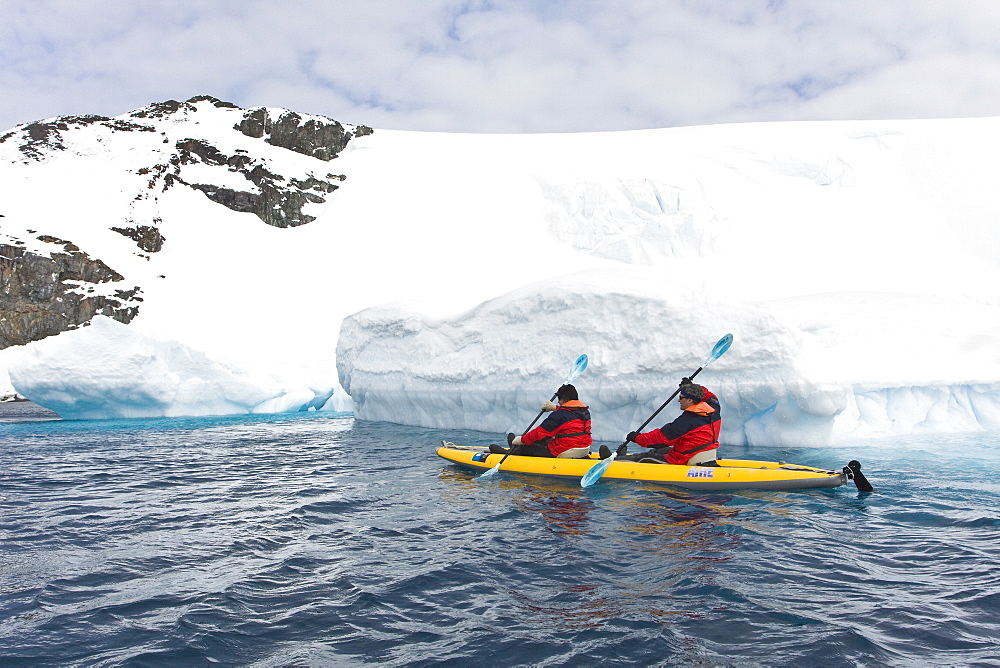 Lindblad Expeditions guests kayaking beside icebergs in Antarctica as part of expedition travel. NO MODEL RELEASES FOR THIS IMAGE.