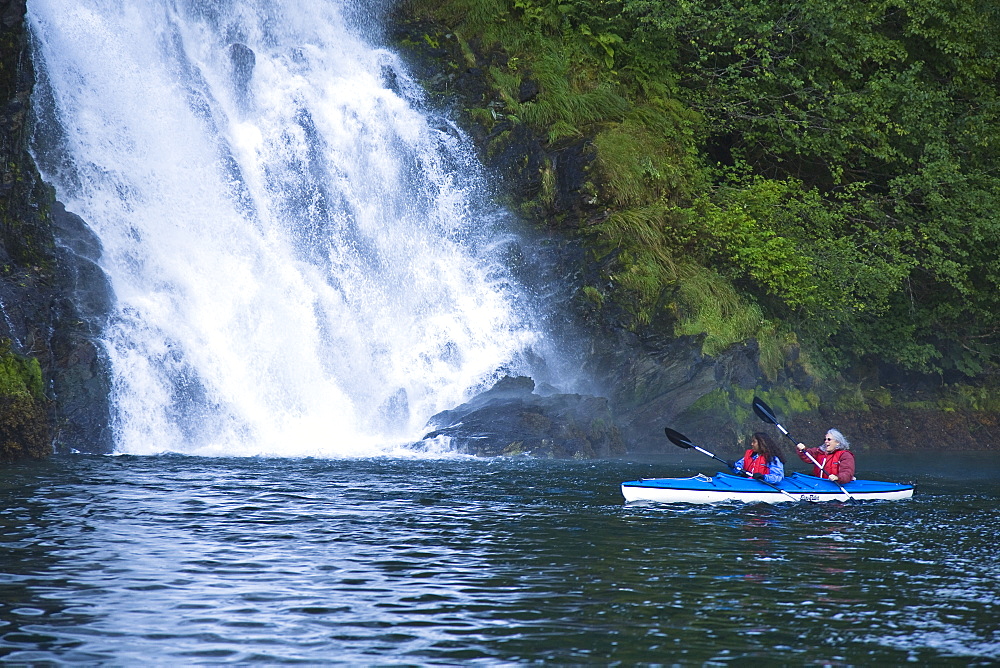 Kayaking in Red Bluff Bay on Baranof Island in Southeast Alaska, USA. Pacific Ocean. Kayak property release is DB051905. No model release.