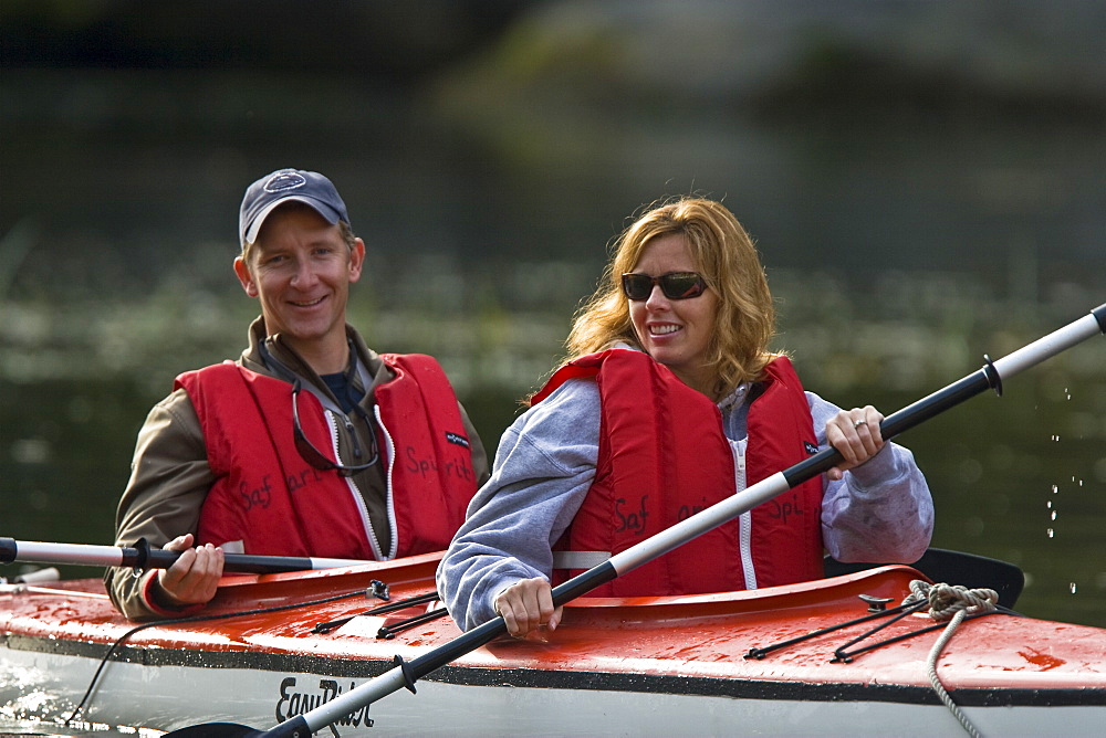 Kayaking in Red Bluff Bay on Baranof Island in Southeast Alaska, USA. Pacific Ocean. Kayak property release is DB051905. Model released numbers BM0807, JP0807, or DP0807.