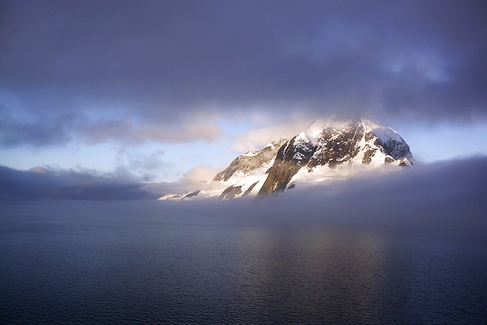 Shroud covered mountain peak in the magnificent Lemaire Channel, Antarctica.