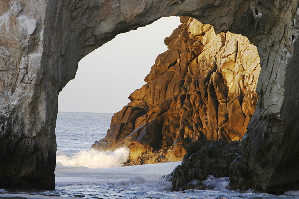 Sunrise on the famous finisterra arch at (land's end) rock formation in Cabo San Lucas, Baja California Sur, Mexico.