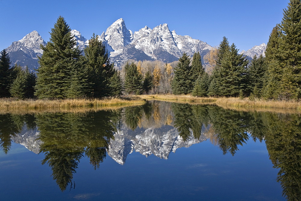 Reflected light on water from the Grand Teton Mountain Range, outside of Jackson Hole, Wyoming. This image was shot from the Schabawacker Landing on the snake river.