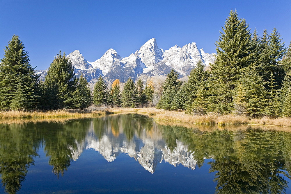 Reflected light on water from the Grand Teton Mountain Range, outside of Jackson Hole, Wyoming. This image was shot from the Schabawacker Landing on the snake river.