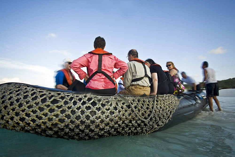 Lindblad Expeditions Guests boarding the Zodiac at Gardner Bay on Espanola Island in the Galapagos Island Archipeligo, Ecuador. No model releases.