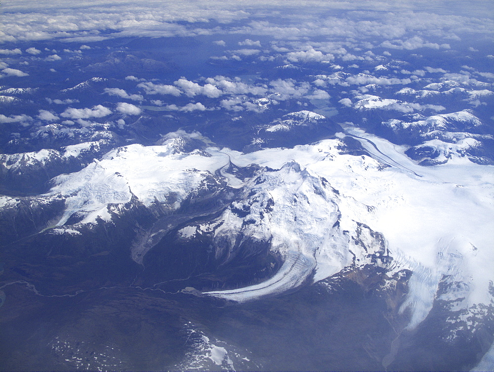 Aerial views of snow-capped mountains, ice fields, and glaciers on a charter flight from Santiago, Chile to Ushuaia, Argentina