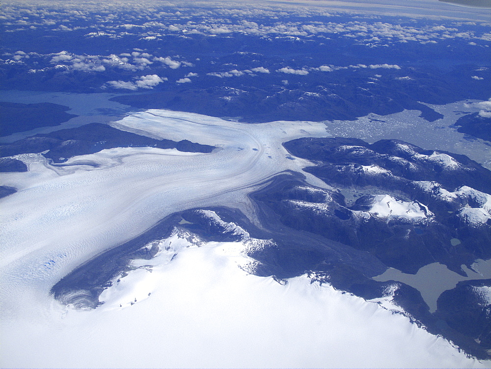 Aerial views of snow-capped mountains, ice fields, and glaciers on a charter flight from Santiago, Chile to Ushuaia, Argentina