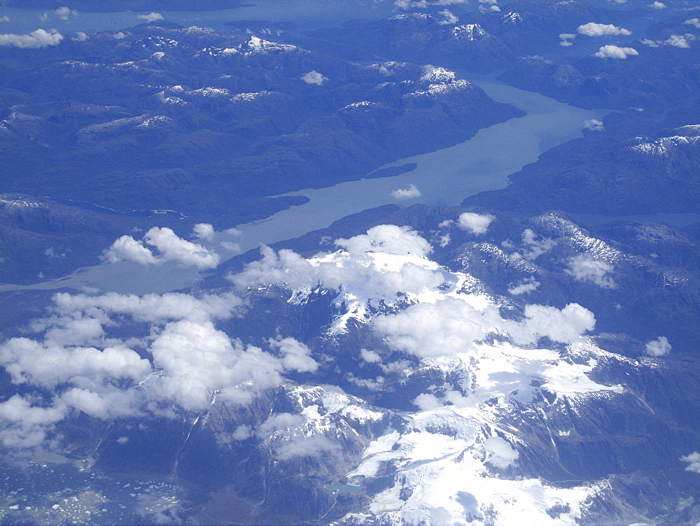 Aerial views of snow-capped mountains, ice fields, and glaciers on a charter flight from Santiago, Chile to Ushuaia, Argentina