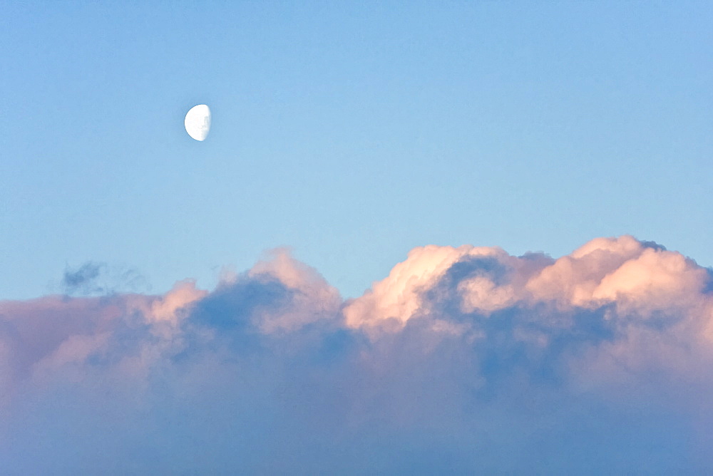 The Lindblad Expedition ship National Geographic Explorer in Dahlman Bay in late evening light as the waxing moon rises on the west side of the Antarctic Peninsula in Antarctica. 