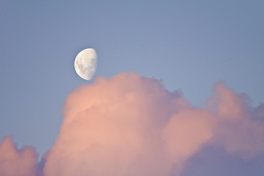 The Lindblad Expedition ship National Geographic Explorer in Dahlman Bay in late evening light as the waxing moon rises on the west side of the Antarctic Peninsula in Antarctica. 