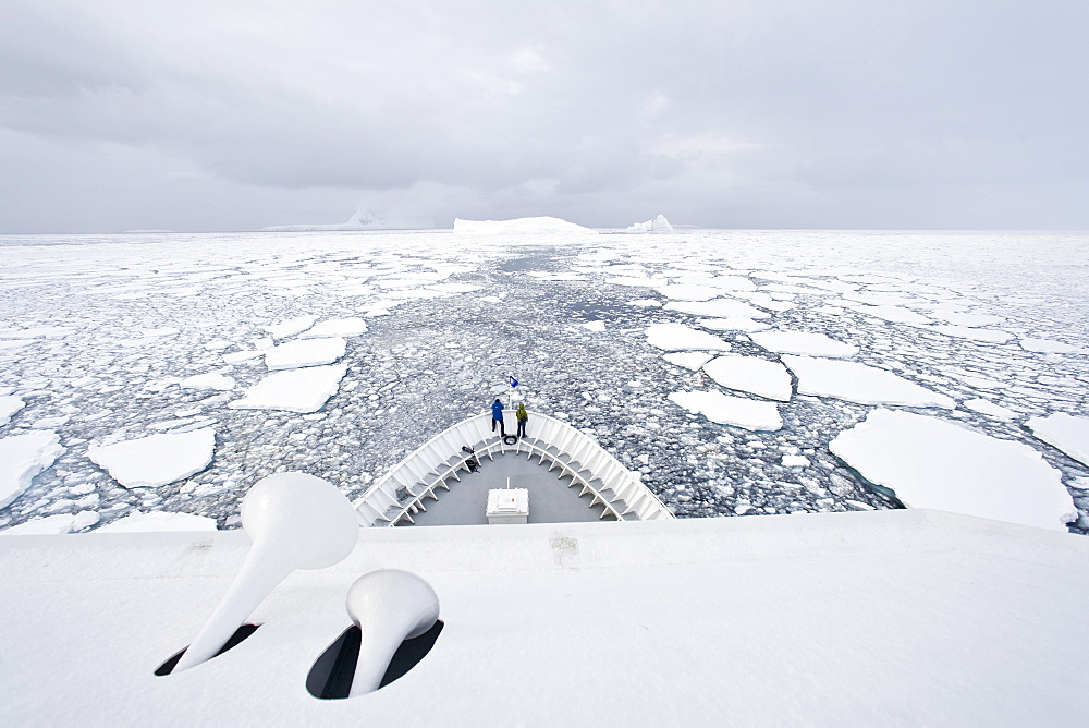 The Lindblad Expeditions ship National Geographic Explorer pushes through ice in Crystal Sound, south of the Antarctic Circle