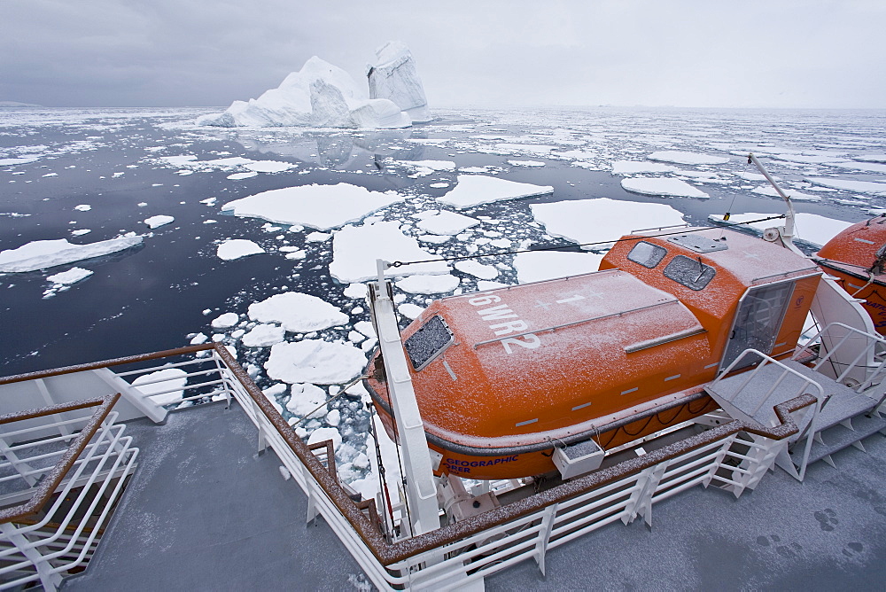 The Lindblad Expeditions ship National Geographic Explorer pushes through ice in Crystal Sound, south of the Antarctic Circle