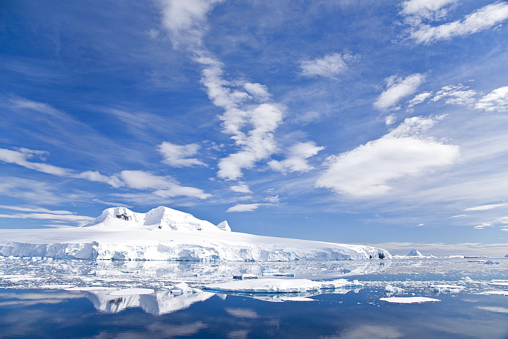 The Lindblad Expeditions ship National Geographic Explorer pushes through ice in Crystal Sound, south of the Antarctic Circle