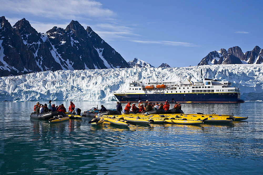 Guests from the Lindblad Expedition ship National Geographic Explorer kayaking near Monaco Glacier on Spitsbergen Island in the Svalbard Archipelago