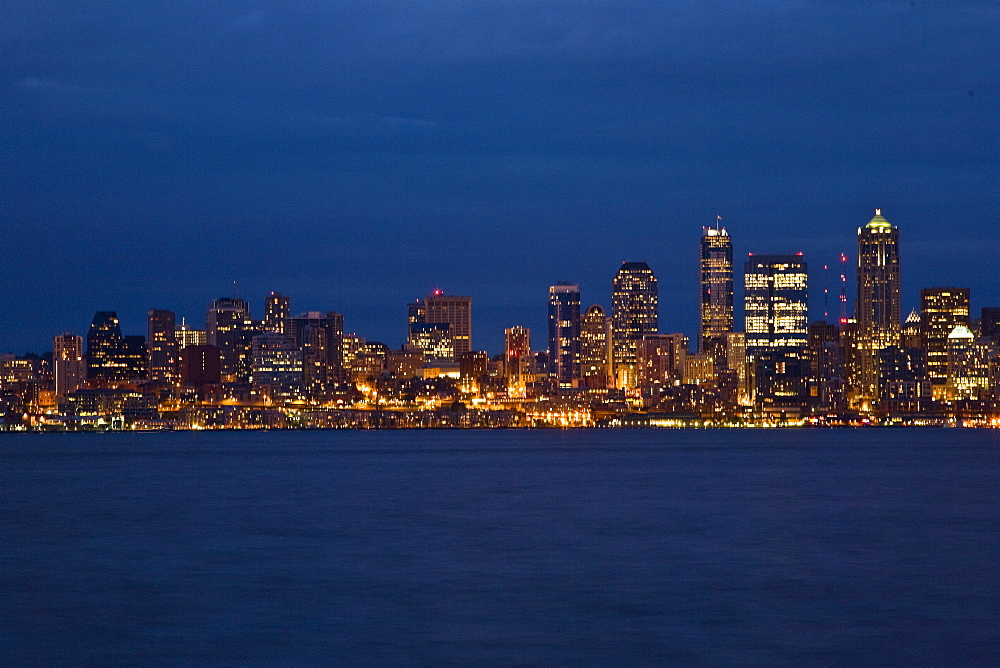 Views at night of downtown Seattle, Washington State, USA. Pacific Ocean.  No model or property releases are available for this image.