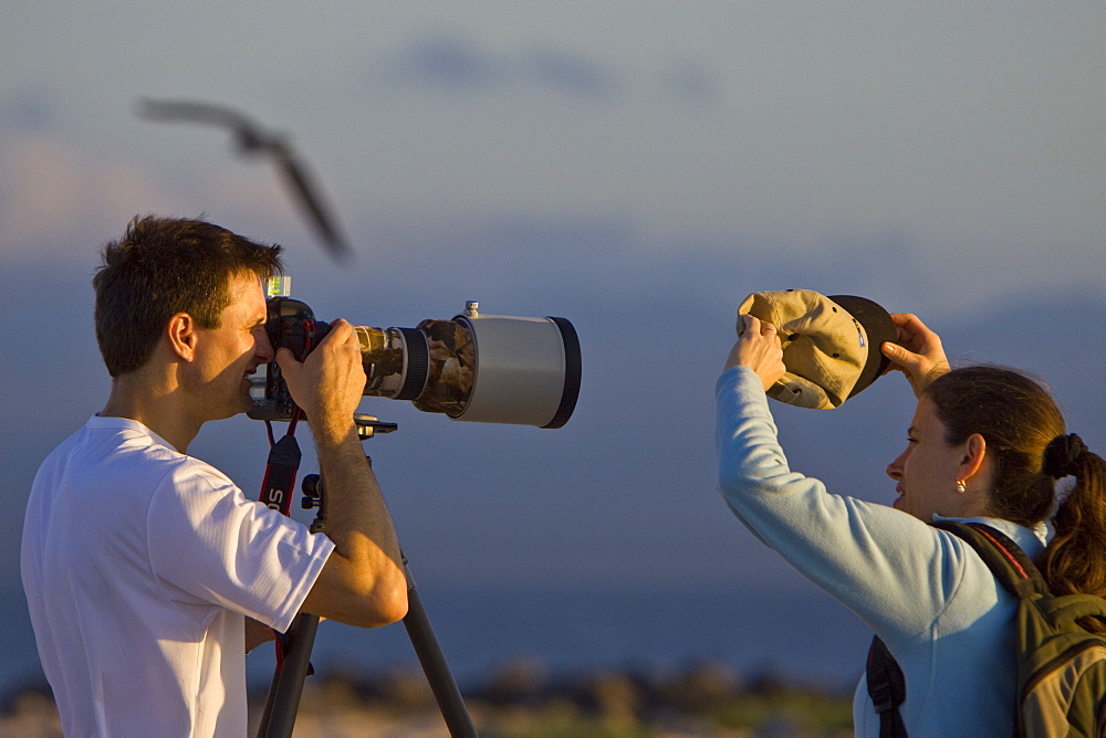 Lindblad Expeditions Guests working as a team to take phoptographs in the Galapagos Island Archipeligo, Ecuador. No model release available for this image.