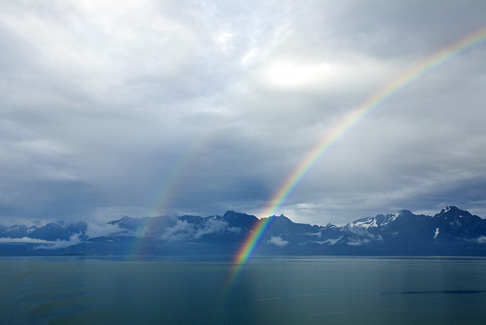 Rainbow after a light rain in Glacier Bay National Park in Southeast Alaska, USA. Pacific Ocean.