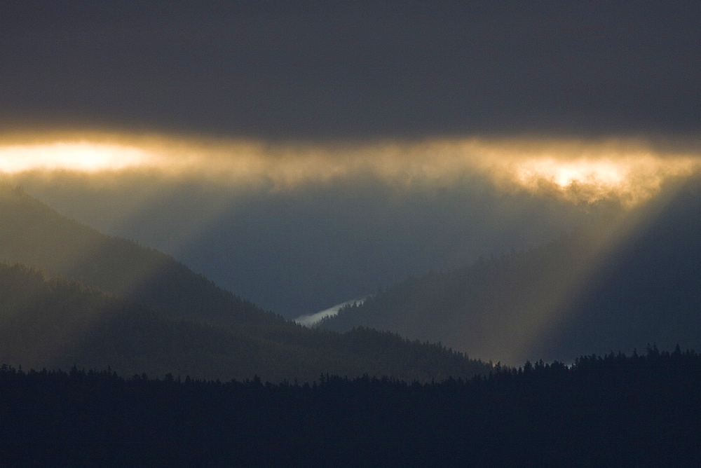 Dramatic early sunrise light over Admiralty Island from Chatham Strait in Southeast Alaska, USA. Pacific Ocean.